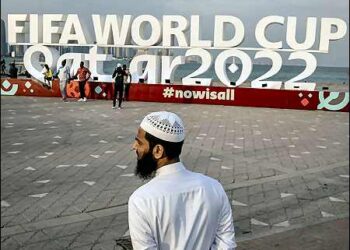 A Muslim man is pictured in front of a FIFA World Cup Qatar 2022 sign ahead of the World Cup, Doha, Qatar - November 17, 2022. Photo: Reuters