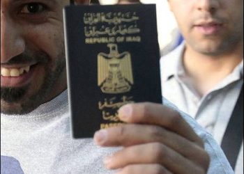 An Iraqi holds his passport at Najaf airport, Iraq, 2015> Photo: Reuters.