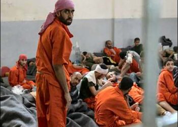 Islamic State militants sit on the floor in Gweran prison in Hasaka, Syrian Kurdistan (Rojava), October 26, 2019. Photo: AFP