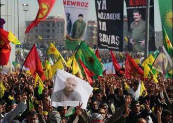 Thousands of Kurds, some dressed in PKK guerrilla outfits, hold up a poster of jailed Kurdish rebel leader Abdullah Öcalan as they demonstrate during the Kurdish New Year (Newroz) celebrations in the main Kurdish city of Diyarbakir (Amed), in Turkish Kurdistan (Bakur), on March 21, 2014.. Photo: AP