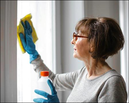 Woman cleaning window