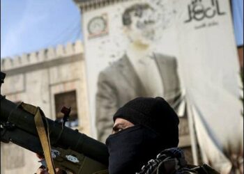 A Syrian Islamist opposition fighter holds a rocket launcher in front of the provincial government office with Assad portrait, in the aftermath of the opposition’s takeover of Hama, Syria, December 6, 2024. Photo: AP