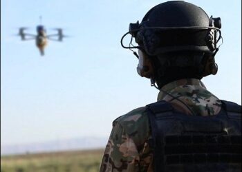 A member of the Syrian Kurdish SDF forces operating an armed drone