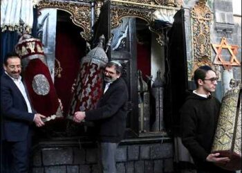 Henry Hamra and members of a Syrian Jewish delegation who are visiting Syria for the first time in decades hold a Torah Case in a Jewish synagogue in Damascus, Syria February 18, 2025. Photo: Reuters
