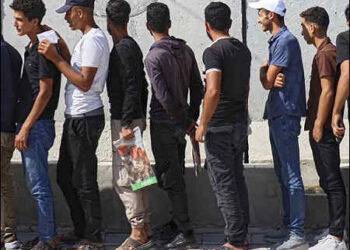 Young Kurdish men line up to sign up to join Syrian government’s General Security forces at a police station in Turkey-occupied Kurdish city of Afrin, Syrian Kurdistan (Rojava), an area in the country’s north from which Kurds were forcibly displaced years ago, August 21, 2025. Photo: AP