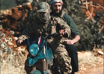 Syrian Interim President Ahmed al-Sharaa, also known as Abu Mohammed al-Golani, seen sitting behind the driver on a motorbike during his time as leader of the HTS Islamist group in Syria, 2024. Photo: X/ enhanced by iKurd.net