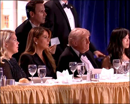 U.S. President Donald Trump looks toward the source of gunfire during the White House Correspondents’ Dinner