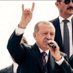 Turkish President Recep Tayyip Erdogan salutes crowd with nationalist Grey Wolf sign