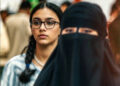 A modern Kurdish woman and a Salafi Muslim woman wearing a niqab at the Sulaimani Book Fair, in Iraqi Kurdistan, October 2025. Photo: Channel8.com/enhanced by iKurd.net